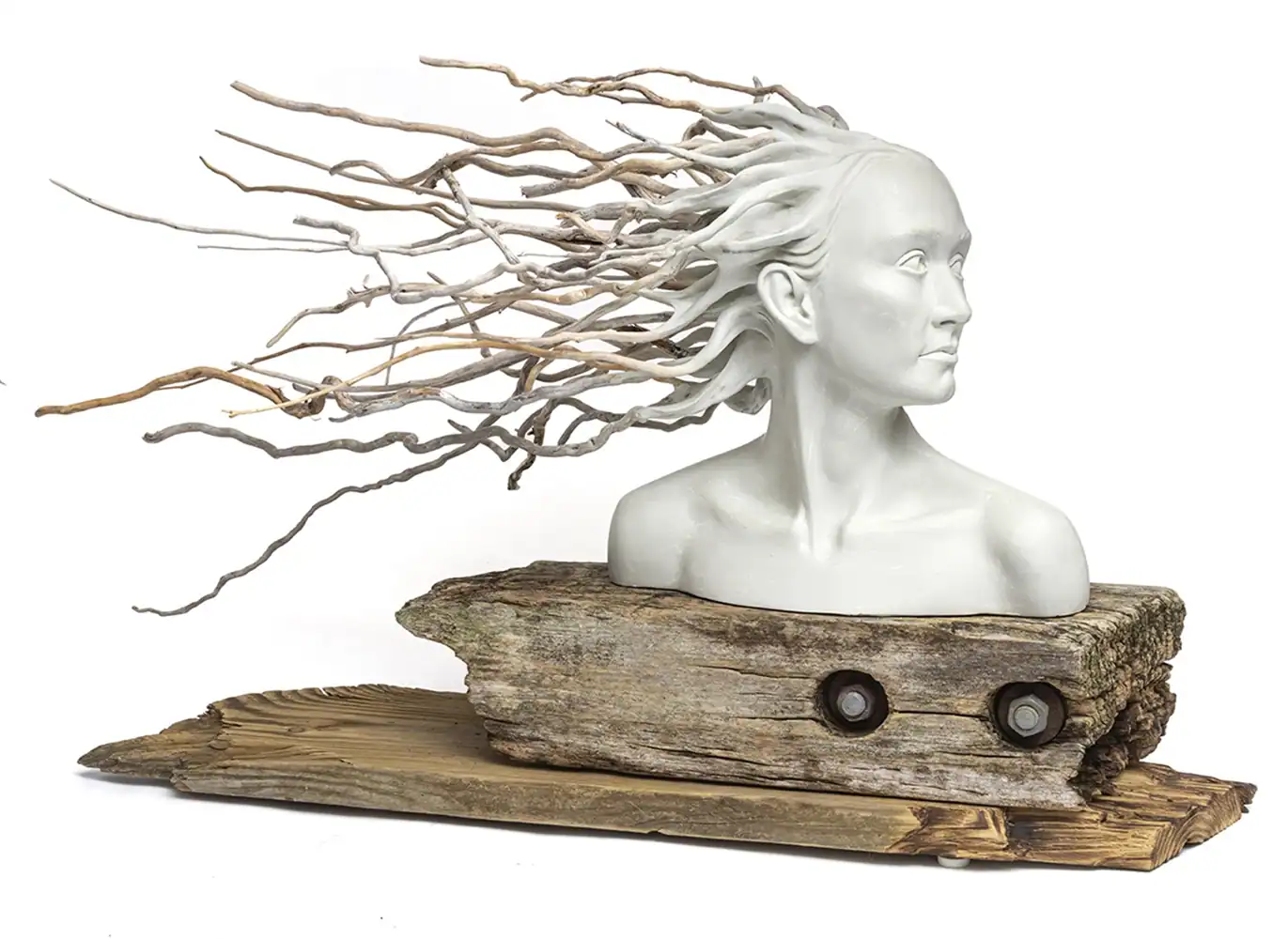 Intriguing sculpture of a woman’s bust with wood and driftwood hair, part of the Threshold Exhibition.