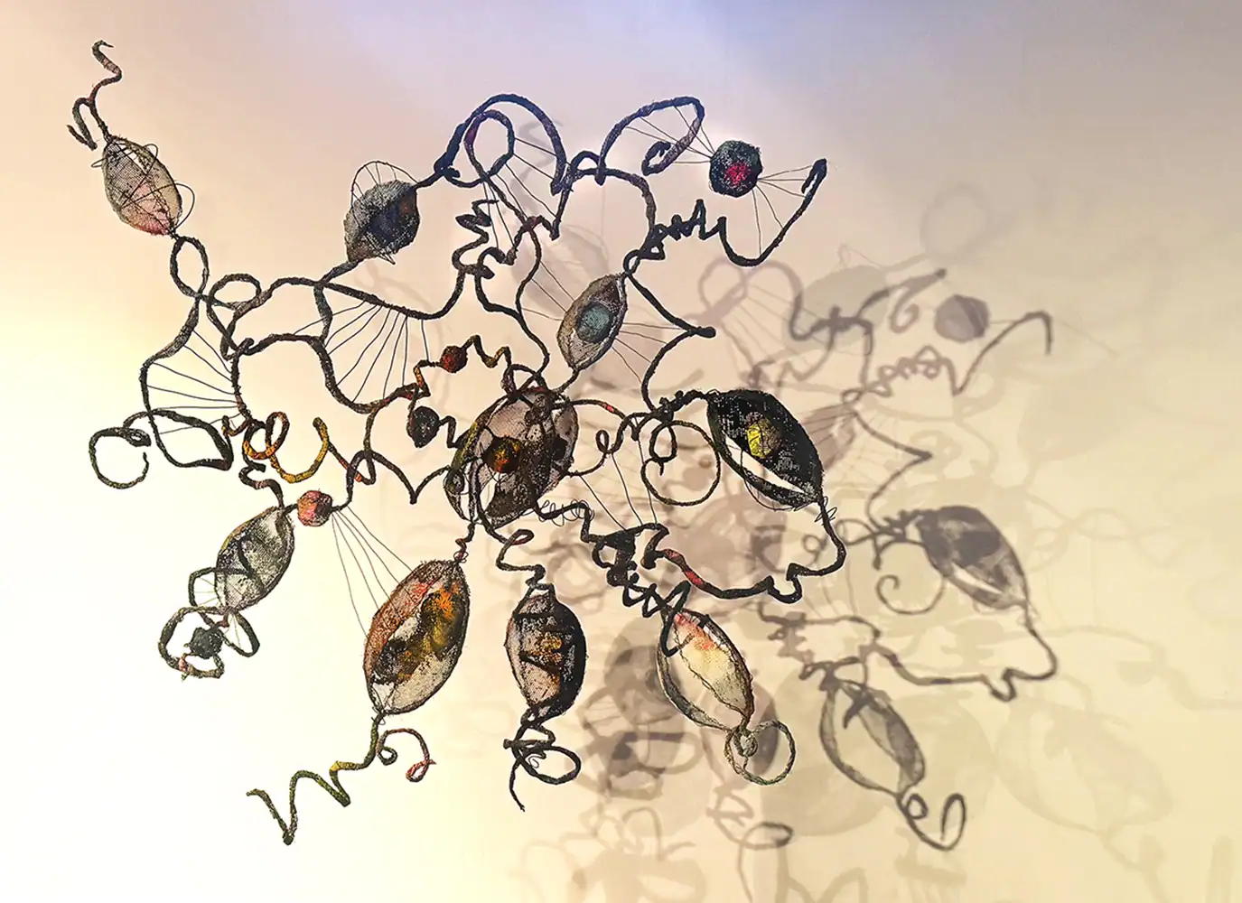 Intricate wire sculpture artwork showcased at Threshold Exhibition, emphasizing contemporary art and innovative sculpture techniques.